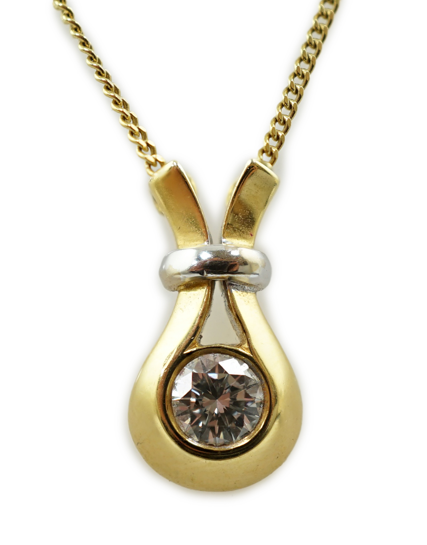 A modern 18ct gold and solitaire diamond set pendant, on an 18ct gold fine link chain